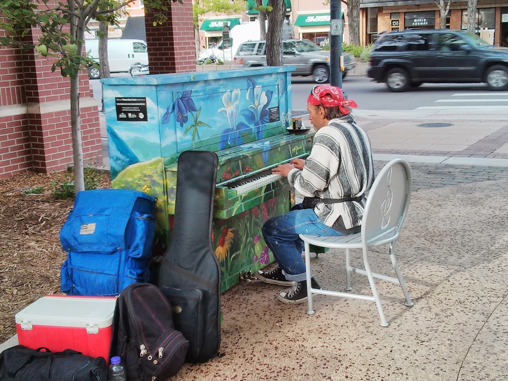 This guy was playing for tips. He was really good! Though I have no idea what he does with that piano when he's done for the day.