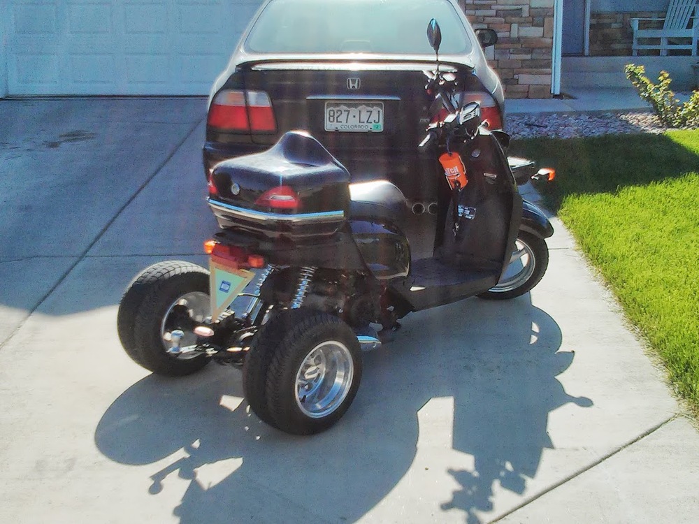 Yep, some nut decided the right thing to do was trike a 50cc motorscooter. Welcome to Colorado!