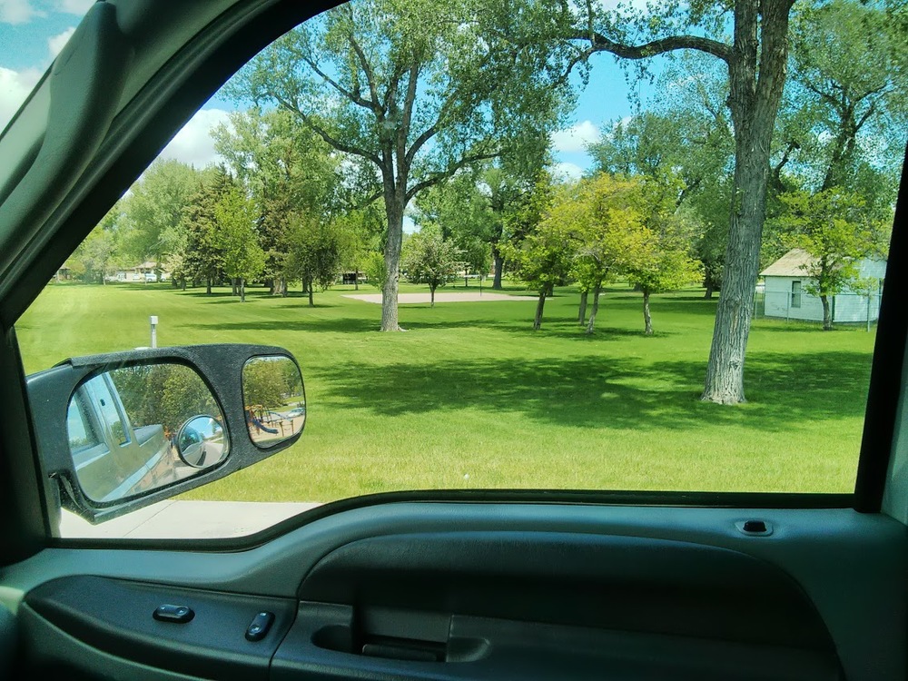 The train was beside a park, which was rather scenic