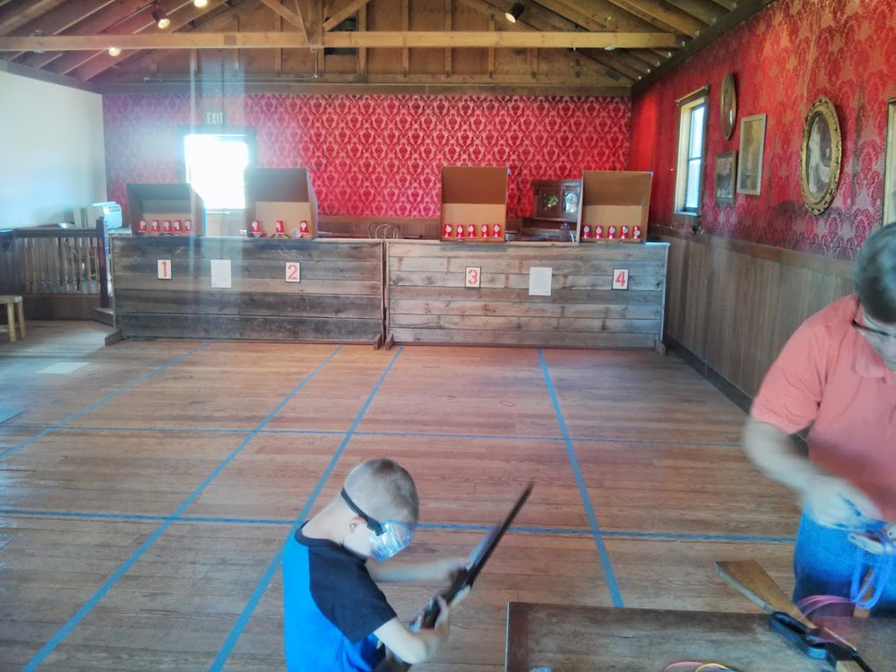 In celebration of an annual summer festival, several faux storefronts were open with crafts and games. Here, people (usually children, but you know me...) were invited to practice shooting cups with rubber band rifles. I didn't do too terribly :)